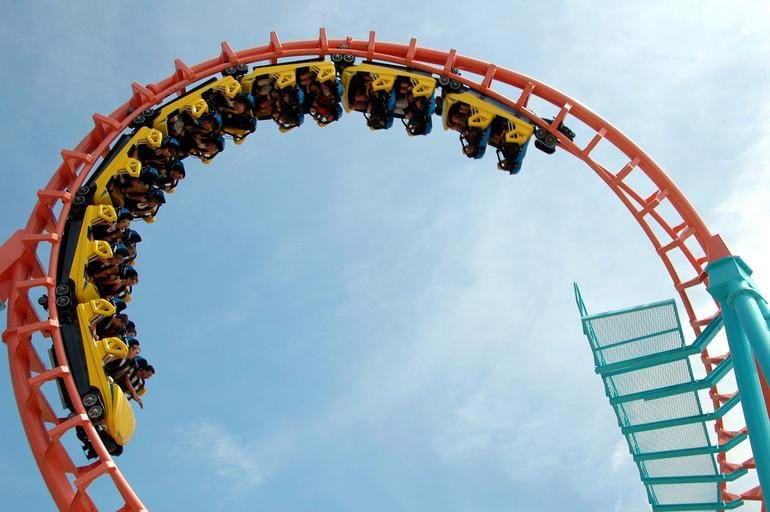 An image of a full roller coaster going around a loop. 