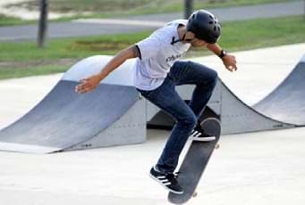A skateboarder doing a trick in midair.