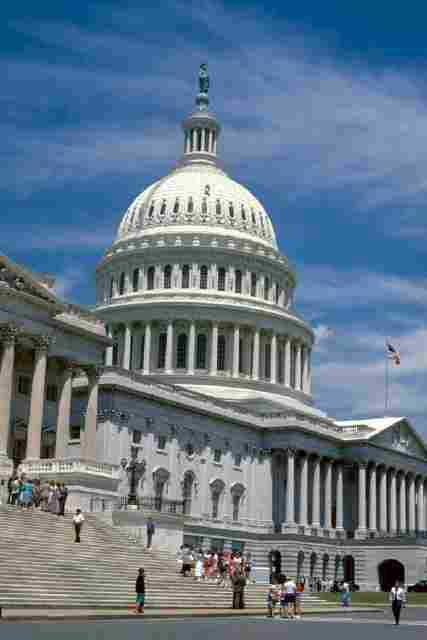 Photo shows the steps leading up to the white, domed Capitol building.