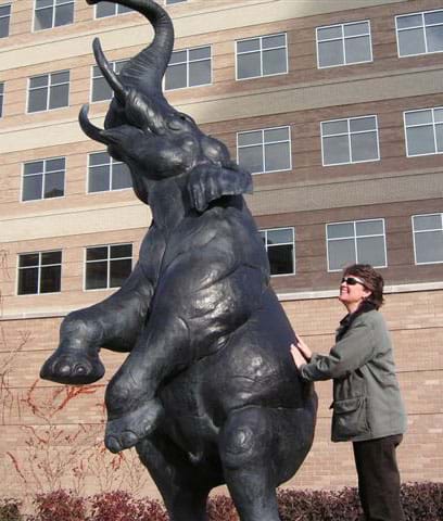 Outdoor sculpture of an elephant rearing on his back legs.