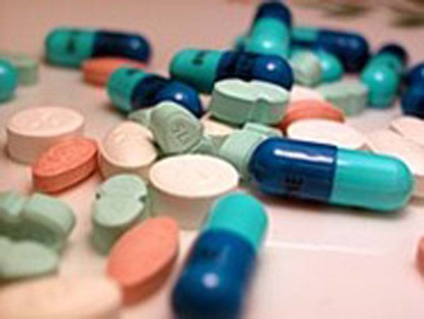 Various pills scattered on a table.