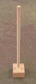 Photo shows a dowel rod attached vertically to the middle of a wooden block.