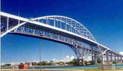 Photo shows a combination steel arch and beam bridge