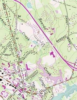 A topographic map showing many distinct features: lines, which represent elevation and colors, which indicate water (blue), tree cover (green) and no tree cover (white).