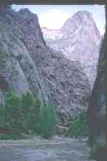 Photo shows a v-shaped valley with a river at its base.