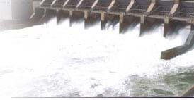 A photograph shows rushing water flowing through a dam.