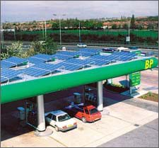 Photo of shiny, blue panels covering the flat roof of a gas station canopy.