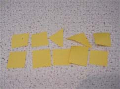 A photograph of 10 yellow pieces of construction paper, representing chips.