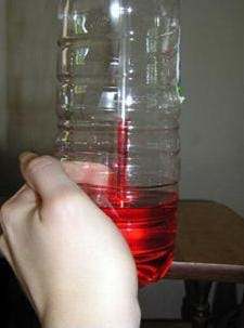 Photo shows a water bottle with some red liquid in the bottom and a straw in the liquid. Red liquid rises part way up the straw with it labeled 70°F.