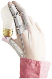 A photograph of a human hand that has been superimposed with mechanical fingers. The hand, which shows jointed finger, holds a light bulb.