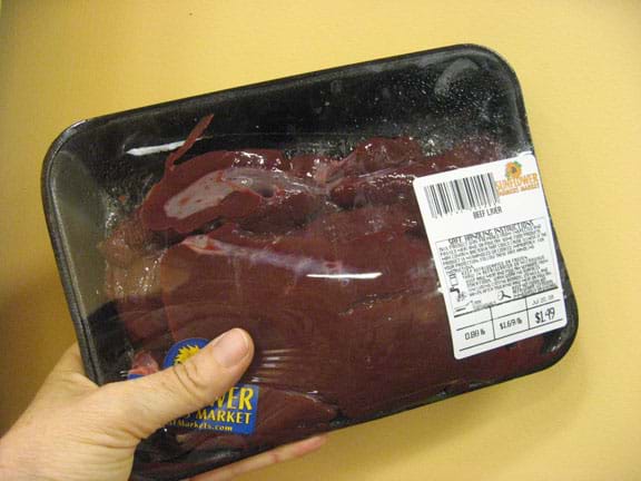 Photo shows reddish-brown meat wrapped in plastic wrap.