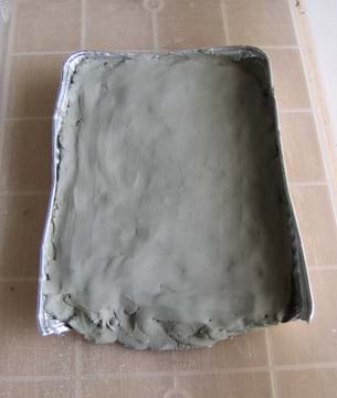 Photo of clay-covered baking pan.