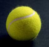 Photo of a yellow tennis ball.