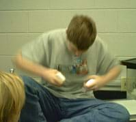 Photo of a boy pulling a piece of soap apart.