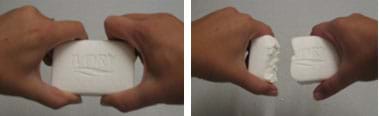 Two photos show two hands, one on each end of a bar of soap, pulling it apart.