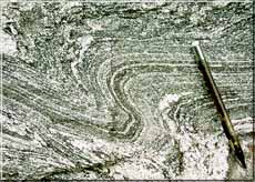Photo of black and white curvy-striped rock.