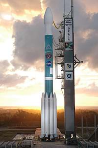 A photograph shows a rocket poised, nose up, on a launchpad.