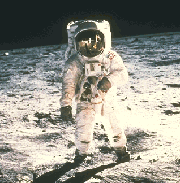 Photo of a man in a spacesuit walking on the Moon's surface.