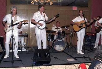 Photos shows a six-man band performing on an elevated stage.