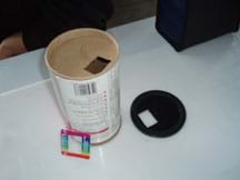 Photo shows the diffraction grating, lid with hole, and container with hole.