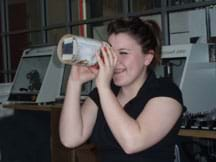 A student looks through the finished spectrograph.