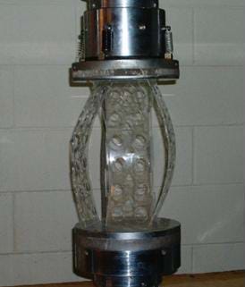 Photo of an acrylic tower under compression on a universal testing machine for compression testing.