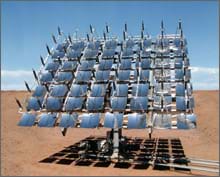 Photo shows 56 concave mirrors forming a panel mounted on a stand in the sunny desert.
