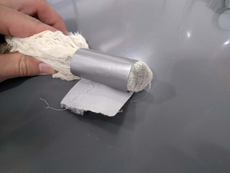The first of three pictures showing possible steps that students may do to create a quicksand model. This is a picture of cheesecloth fitted to a tube using duct tape.