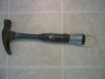 Photo shows a hammer with a string loop attached to its handle end with duct tape.