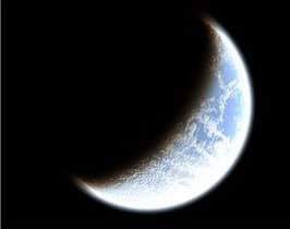 A photograph shows a crescent moon, just a slice of the full orb.