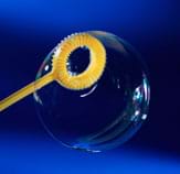 Photo shows a yellow plastic lifesaver-shaped item with a handle; a bubble sits on its circular opening.