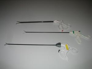 Three grasping devices with handles that look like scissors handles.