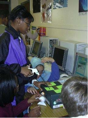 These students are doing surgery on a cardboard box.