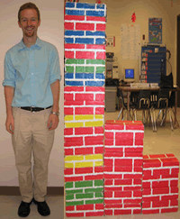 A photograph shows an adult standing next to a stack of shoebox-sized building blocks as tall as he is.