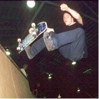 Photo of young man doing a skateboard trick.