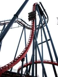 A photo of a roller coaster shows a car coming down the first big hill.