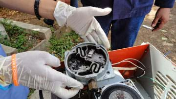 A photograph shows gloved hands holding a disassembled suction pump motor with dried blood clogging the inside of the motor.