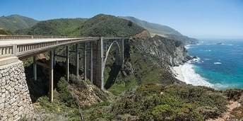 Concrete Bridge crossing a wide creek.