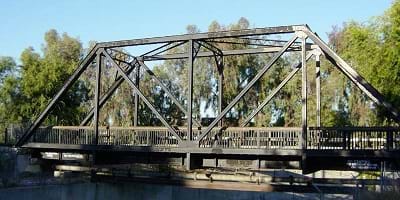 A steel truss bridge built over a river.
