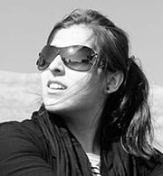 A photograph shows a girl who is wearing dark sunglasses.