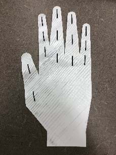 A 3D printed glove. The hand-shaped white print has black lines that drawn on that represent joints.