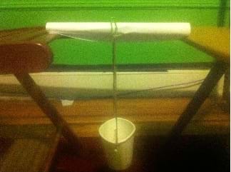 Photo shows a simple student-constructed boom with a "weight" cup hanging from the boom.