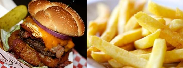 Two photos: A burger in a bun with lettuce, onion rings, bacon, a fried egg, cheese and red onion. Up-close picture of golden french fries.