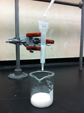 Column set up: The uncapped column is holding milk, which is dripping into a beaker below.
