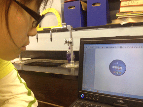 A student checks the time on a laptop for the experiments.