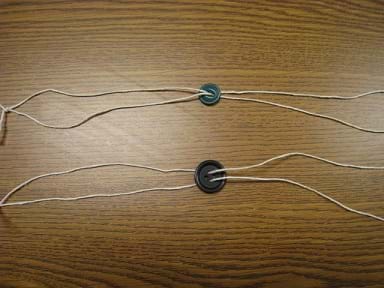 Photo shows two different-sized threaded buttons with different moments of inertia.