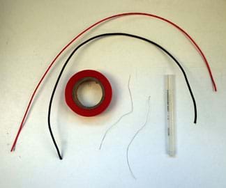 A photograph shows two 20-cm lengths of insulated wire, a roll of electrical tape, a plastic pen barrel and two 10-cm lengths of non-insulated nichrome wire.