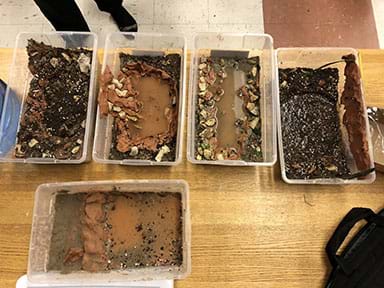 Student models: Tubs with materials (sand, clay, rocks, water) of water sources.