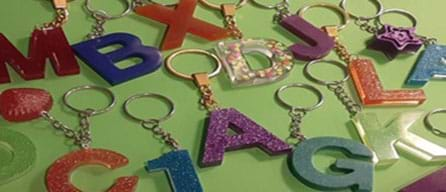 Alphabetic resin key rings sit on a table.