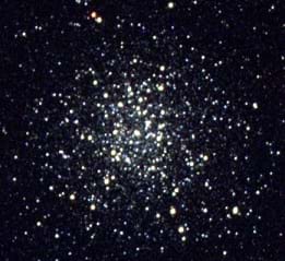 An image showing a color representation of the globular cluster NGC 3201. There are blue, white, and green stars radiating out from the crowded center and fading into black space at the edges.